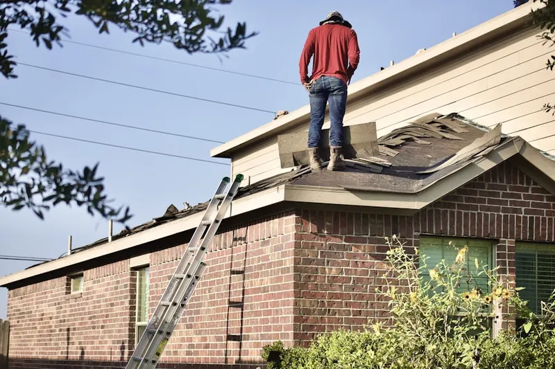 Professional roofer working on a residential roof in Holbrook